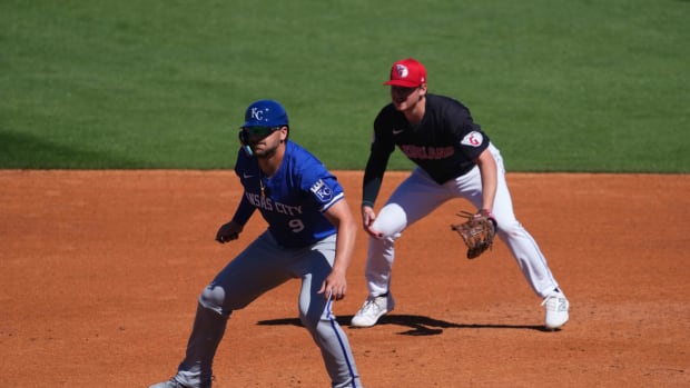 Mar 2, 2024; Goodyear, Arizona, USA; Kansas City Royals first baseman Vinnie Pasquantino (9) leads off first base base as Cleveland Guardians first baseman Kyle Manzardo (73) covers the bag during the second inning at Goodyear Ballpark.